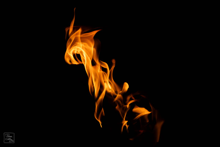 Swirling orange flame on a black background