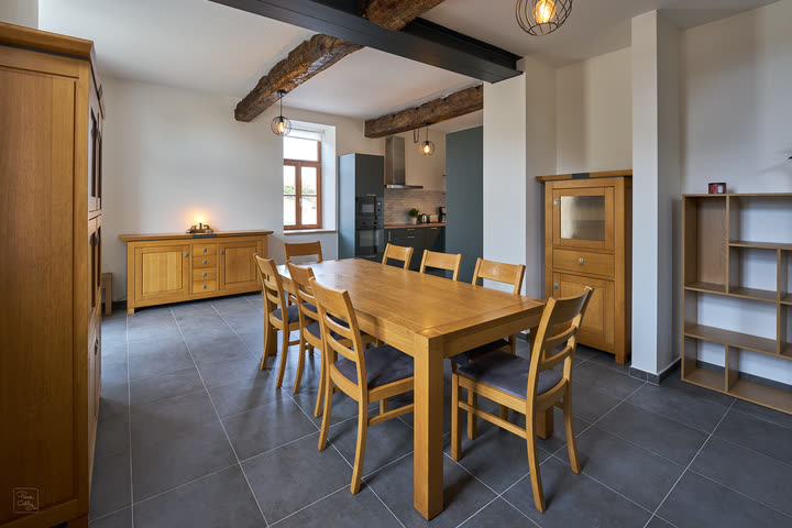 Dining room with an oak table, chairs and exposed beams
