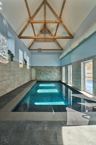 Indoor swimming pool under a timber-framed roof