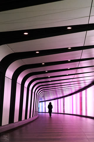 Woman walking in a corridor in London subway