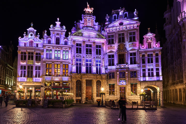 Kissing couple in Grand-Place of Brussels during the evening