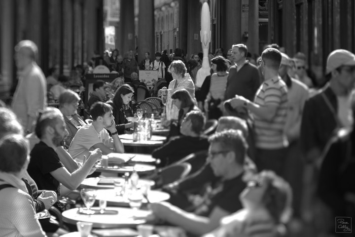 Café terrace crowded with people in the Galeries Royales Saint-Hubert, Brussels